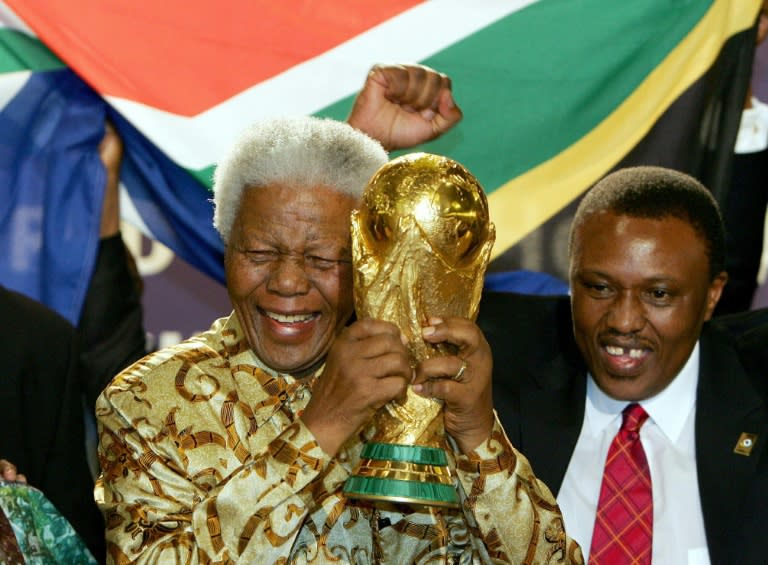 Former South African President Nelson Mandela, pictured here holding the World Cup in 2004, made only a brief appearance at the 2010 finals