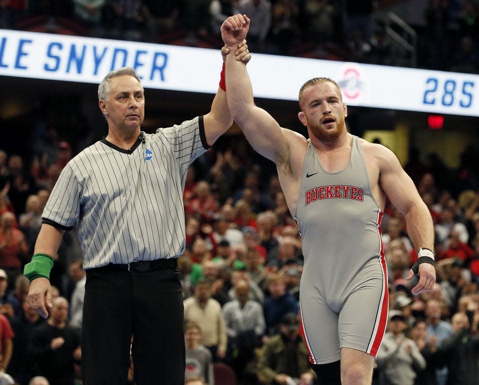 Ohio State's Kyle Snyder celebrates beating Michigan's Adam Conn to win the 285 finals at the 2018 NCAA Division I Wrestling Championships.