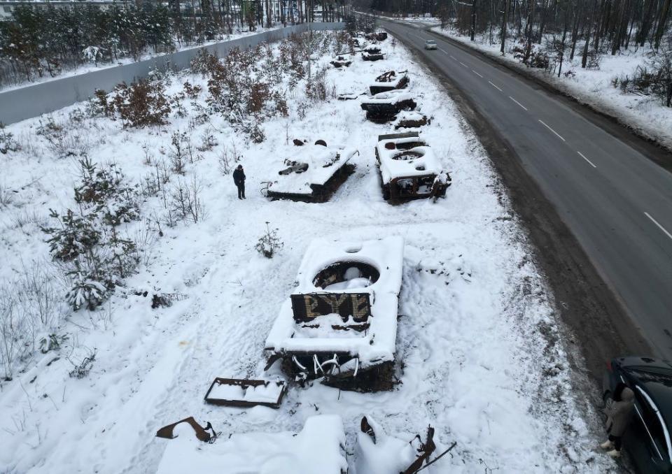 A man looks at the Russian tanks destroyed at the start of Russia's full-scale war against Ukraine near Bucha, Ukraine, on Dec. 5, 2023. (Jeff J Mitchell/Getty Images)