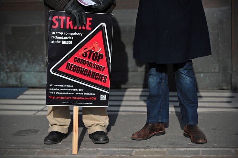 A BBC employee holds a placard outside Broadcasting House in central London on February 18, 2013. BBC journalists staged a 24-hour strike on Monday in protest at job cuts, preventing the transmission of the flagship Today morning news programme and several other television and radio shows