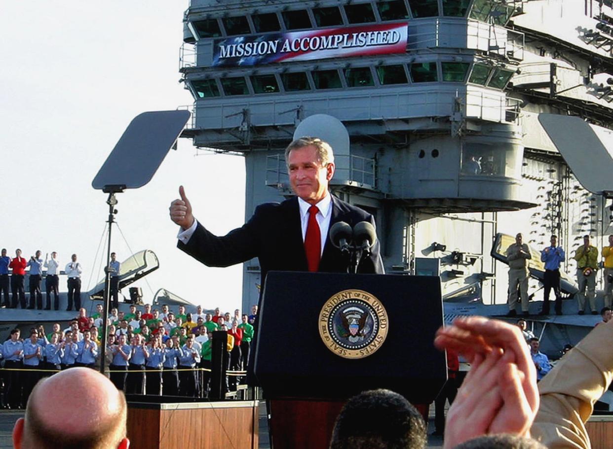 President Bush flashes a "thumbs-up" after declaring the end of major combat in Iraq as he speaks aboard the aircraft carrier USS Abraham Lincoln off the California coast, in this May 1, 2003 file photo.