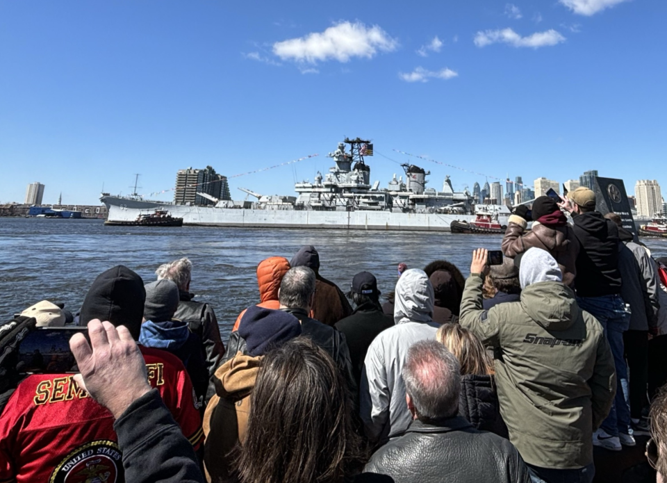 Tugboats escort the Battleship New Jersey down the Delaware River on Thursday.