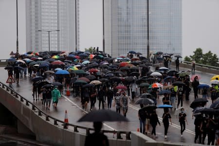 Masked protesters carry umbrellas during an anti-government rally in central Hong Kong