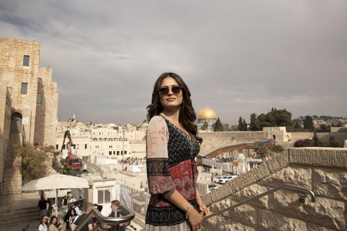 Andrea Meza, the reigning Miss Universe from Mexico, poses overlooking the Western Wall and the Dome of the Rock Mosque as she tours the Old City of Jerusalem, Wednesday, Nov. 17, 2021, ahead of the 70th Miss Universe pageant being staged in the southern Israeli resort city of Eilat next month. She said Wednesday that the long-running beauty pageant shouldn't be politicized, even as its next edition is being held in Israel and contestants have faced pressure to drop out in solidarity with the Palestinians. (AP Photo/Maya Alleruzzo)