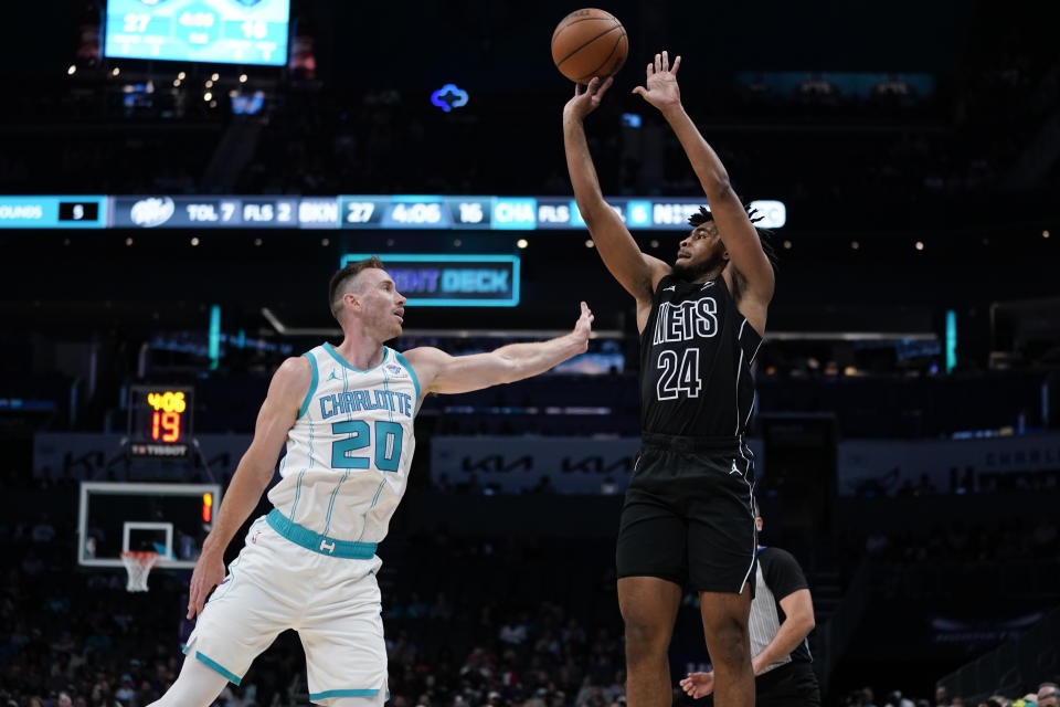 Brooklyn Nets guard Cam Thomas (24) shoots the ball under pressure from Charlotte Hornets forward Gordon Hayward (20) in the first half of an NBA basketball game, Monday, Oct. 30, 2023, in Charlotte, N.C. (AP Photo/Erik Verduzco)