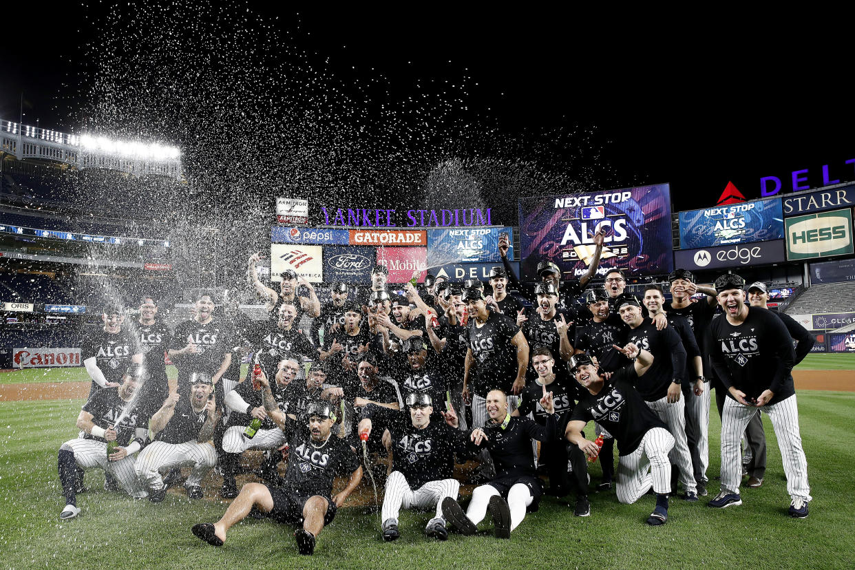 NEW YORK, NEW YORK - OCTOBER 18: The New York Yankees celebrate on the field after defeating the Cleveland Guardians in game five of the American League Division Series at Yankee Stadium on October 18, 2022 in New York, New York. (Photo by Sarah Stier/Getty Images)
