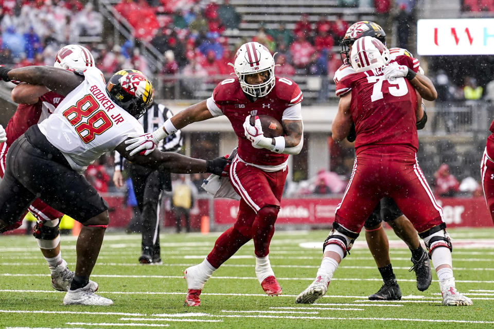 Wisconsin running back Braelon Allen (0) gets past Maryland defensive lineman Anthony Booker (88) during the first half of an NCAA college football game Saturday, Nov. 5, 2022, in Madison, Wis. (AP Photo/Andy Manis)