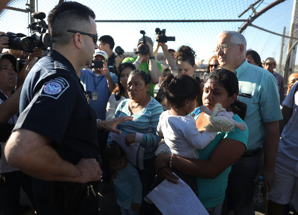 U.S. Border Patrol agent Ray Provencia informs Angelica and Karla (who didn’t want their last names used) that they will have to wait at the Paso Del Norte Port of Entry, where the U.S. and Mexico border meet, for space to open up at the border processing center so they can ask for asylum on June 20, 2018, in El Paso, Texas. (Photo: Joe Raedle/Getty Images)