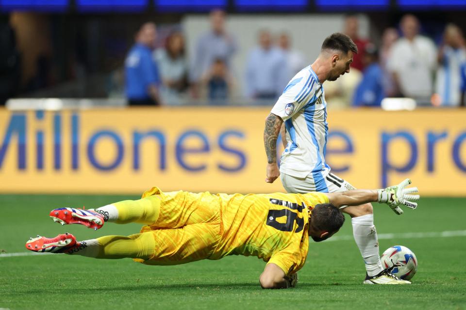 Argentina's forward #10 Lionel Messi fights for the ball with Canada's goalkeeper #16 Maxime Crepeau during the 2024 Copa America in Atlanta, Georgia, on June 20, 2024.