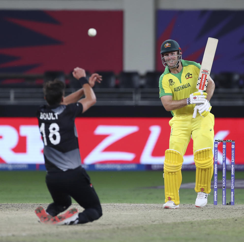 New Zealand's Trent Boult makes an unsuccessful attempt to catch the ball after a shot played by Australia's Mitchell Marsh during the Cricket Twenty20 World Cup final match between New Zealand and Australia in Dubai, UAE, Sunday, Nov. 14, 2021. (AP Photo/Aijaz Rahi)