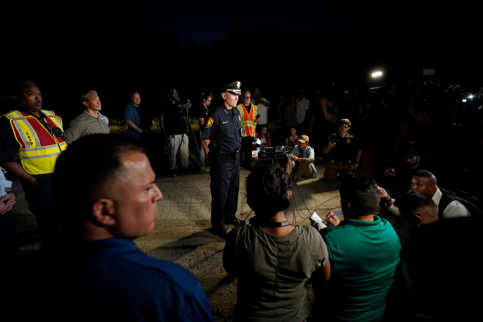 San Antonio Police Chief William McManus, center, briefs media and others at the scene where dozens of people have been found dead and multiple others were taken to hospitals with heat-related illnesses after a semitrailer containing suspected migrants was found, Monday, June 27, 2022, in San Antonio.<span class="copyright">Eric Gay—AP</span>