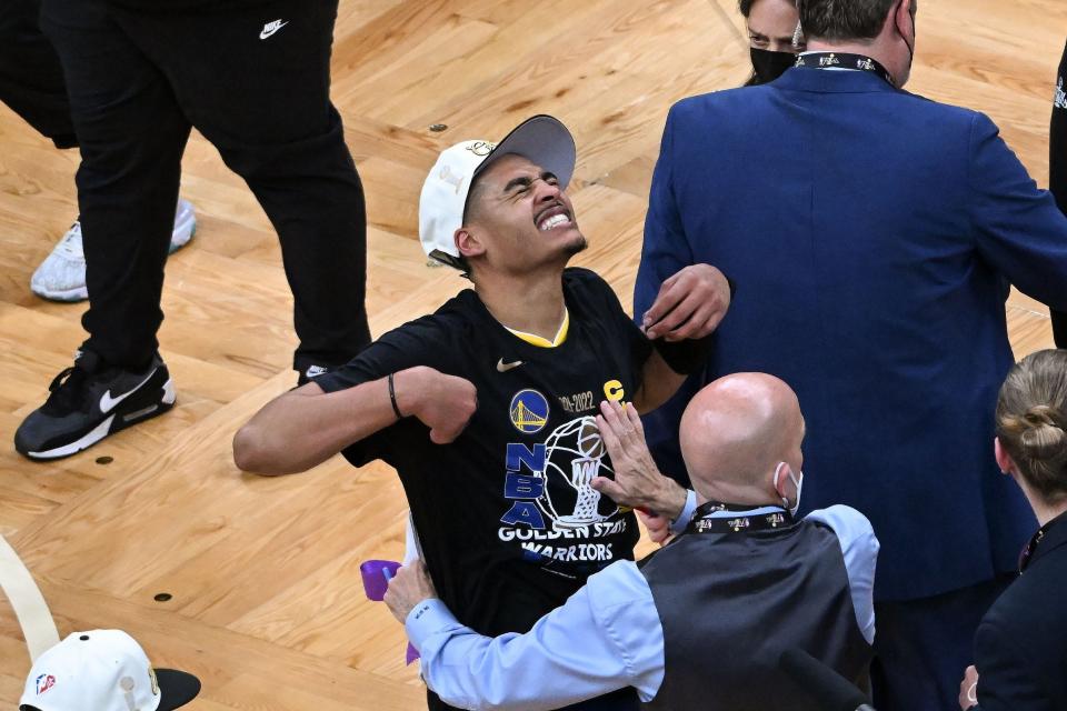 Milwaukee native Jordan Poole celebrates the Warriors' NBA championship Thursday at TD Garden.