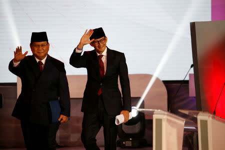 Indonesia's presidential candidate Prabowo Subianto (L) and his running mate Sandiaga Uno wave before a televised debate with opponent Joko Widodo (not pictured) in Jakarta, January 17, 2019. REUTERS/Willy Kurniawan