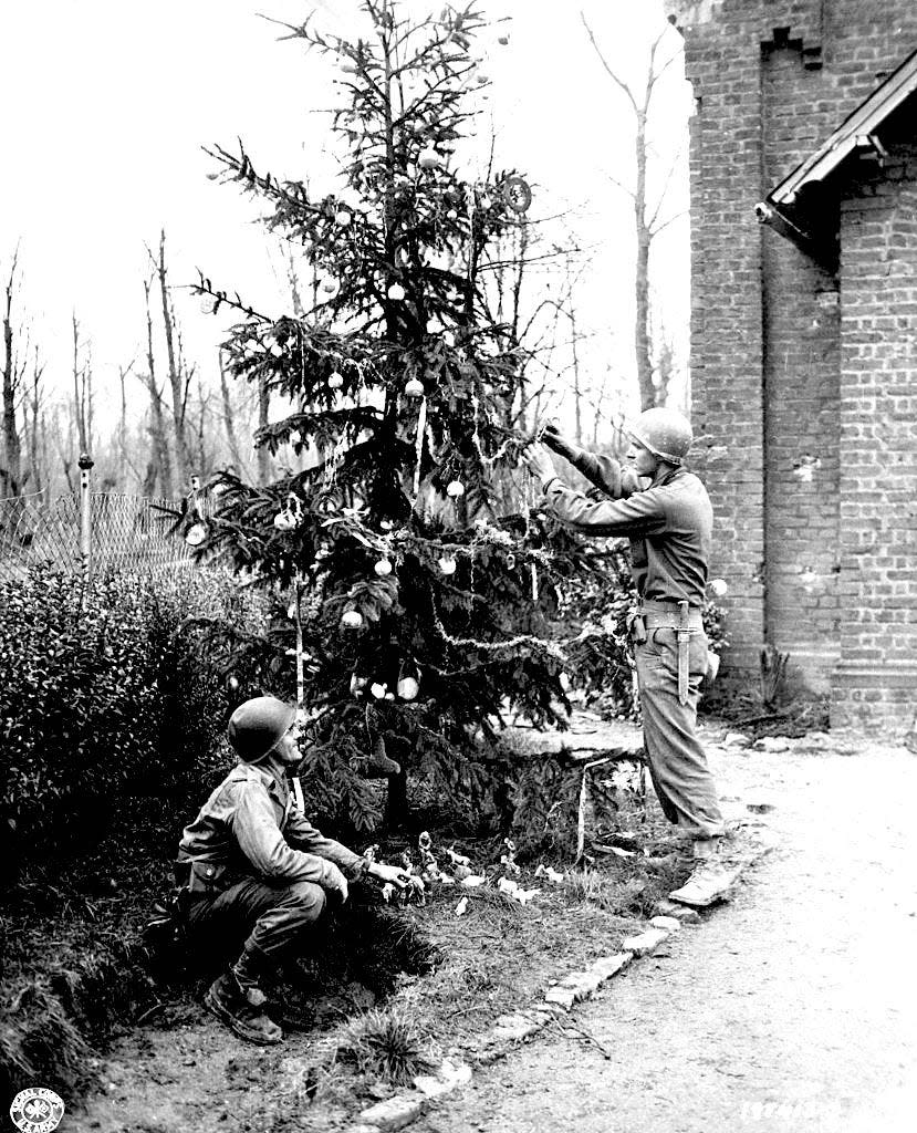 U.S. soldiers create a makeshift Christmas tree in a captured German town in 1944.