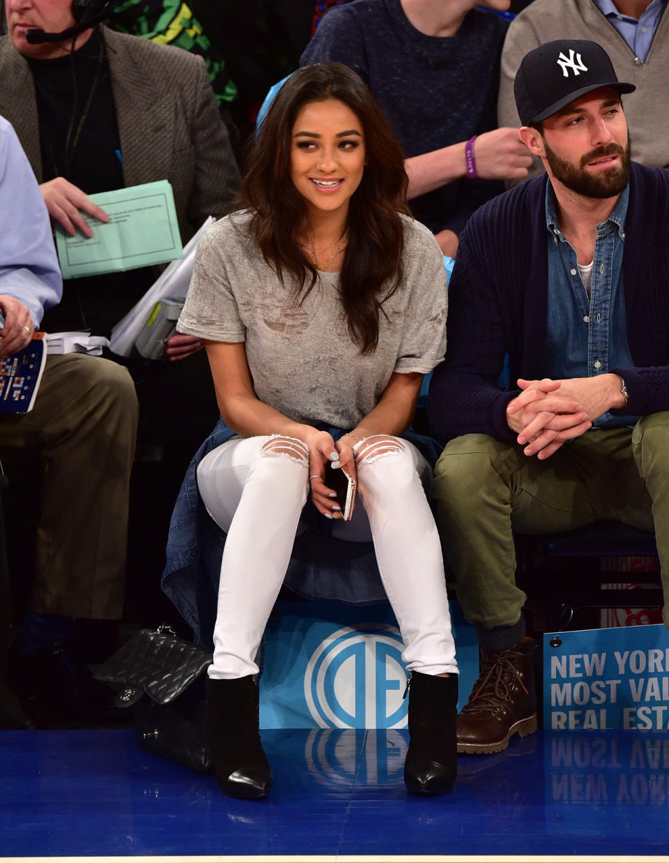 The “Pretty Little Liars” actress is nailing normcore in ripped pants, a gray T-shirt (with burn holes), and a denim shirt tied around her waist. The heels are cute, but ultimately kill the appropriately sporty vibe.