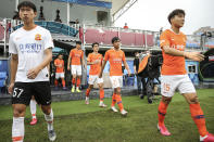 Members of Wuhan FC, then known as Wuhan Zall, prepare for an internal training match in Wuhan in central China's Hubei province on July 2, 2020. The club endured quite an ordeal last year after first being stranded in Spain on a preseason tour as its home city was overrun by the virus, and then fleeing the country just before the outbreak hit Europe hard. (Chinatopix via AP)