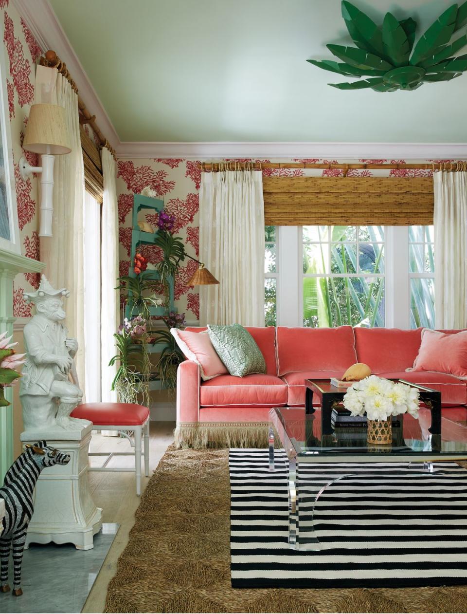 <p>Defined by its extroverted yet cultivated qualities, preppy rooms are "steadfast arenas for the tumble of life," according to Caponigro. Those drawn to the upbeat mode will most certainly love juicy pink and coral tones like those featured on the velvet sofa (Sophia Velvet) and playful wallcovering (Great Barrier Reef) in this Amanda Lindroth–designed living room. </p>