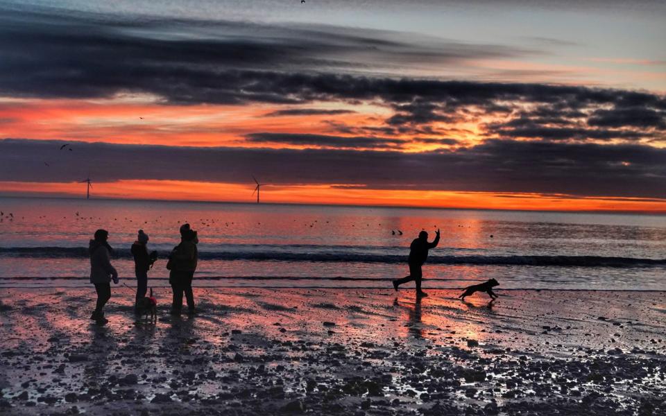 People walking on Blyth beach in Northumberland, Sunday February 28 - Owen Humphreys /PA Wire