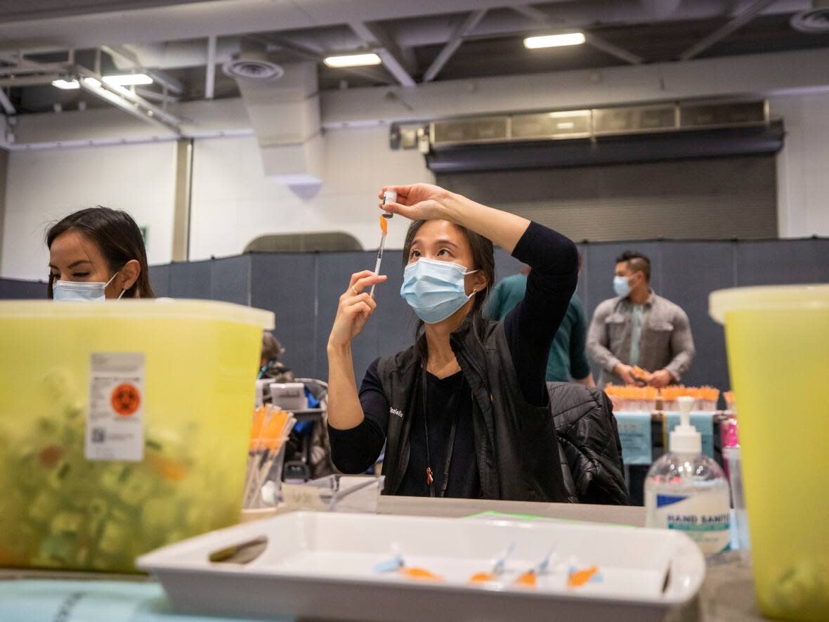 A COVID-19 vaccination clinic at the Vancouver Convention Centre in Vancouver, British Columbia on Thursday, Jan .13, 2022. (Ben Nelms/CBC - image credit)