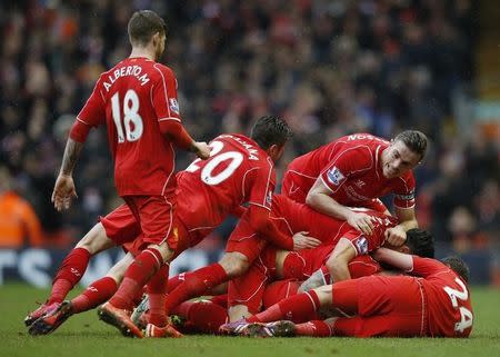 Liverpool's Philippe Coutinho (hidden) celebrates with team mates after scoring the second goal for his side. Liverpool v Manchester City - Barclays Premier League - Anfield - 1/3/15. Reuters / Phil Noble Livepic