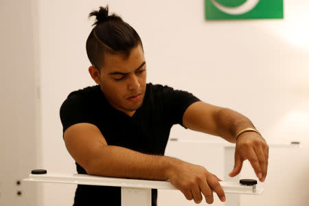 TaskRabbit Tasker Guillermo Rodriguez assembles an IKEA table at the TaskRabbit office in San Francisco, California, U.S., September 13, 2018. Picture taken September 13, 2018. REUTERS/Stephen Lam