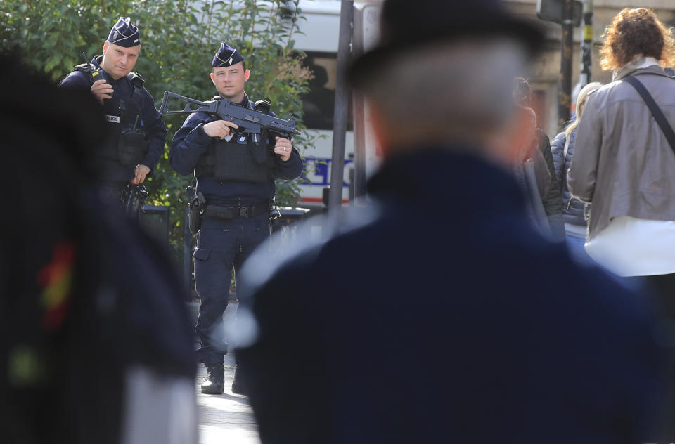 Police officers patrol outside the police headquarters in Paris, Friday, Oct. 4, 2019. The French government says there is nothing to suggest the police employee who stabbed four colleagues to death at Paris police headquarters yesterday was radicalized. (AP Photo/Michel Euler)