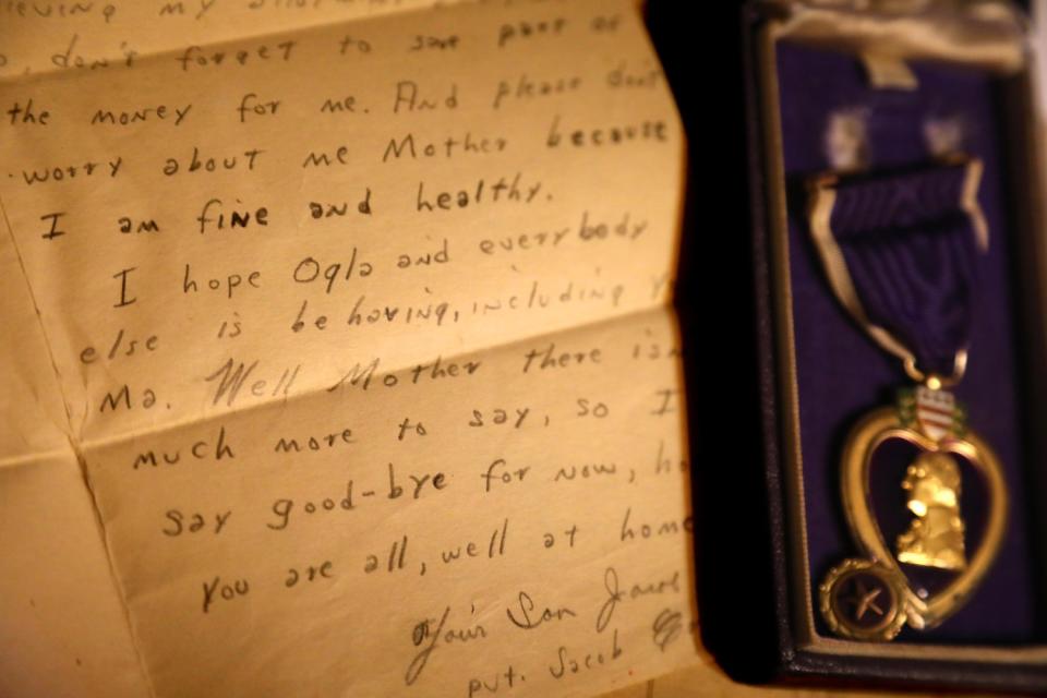 "I am fine and healthy," part of a letter states, shown next to a medal.