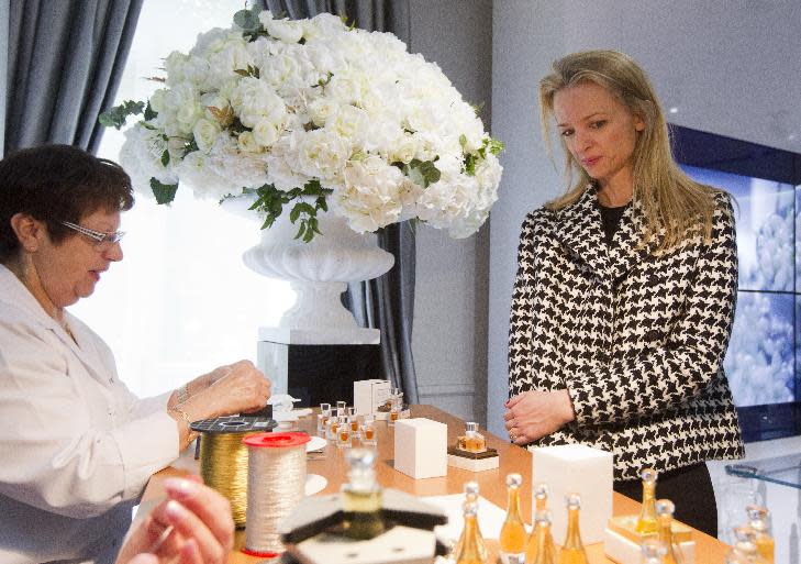 Assistant general manager Christian Dior Couture Delphine Arnault, right, looks a Dior perfume during his visit of "Particular operation days" in LVMH, the world's largest luxury company at the Fashion House Dior in Paris, Saturday June 15, 2013. (AP Photo/Jacques Brinon)