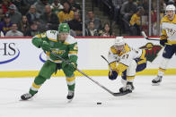 Minnesota Wild center Marco Rossi (23) advances the puck against Nashville Predators defenseman Ryan McDonagh (27) during the first period of an NHL hockey game Sunday, March 10, 2024, in St. Paul, Minn. (AP Photo/Stacy Bengs)