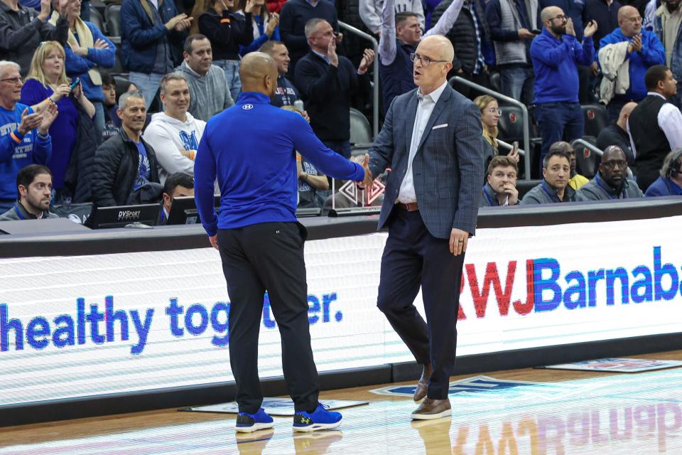 Dec 20, 2023; Newark, New Jersey, USA; Connecticut Huskies head coach Dan Hurley (right) shakes hands with Seton Hall Pirates head coach Shaheen Holloway after the game at Prudential Center. Mandatory Credit: Vincent Carchietta-USA TODAY Sports