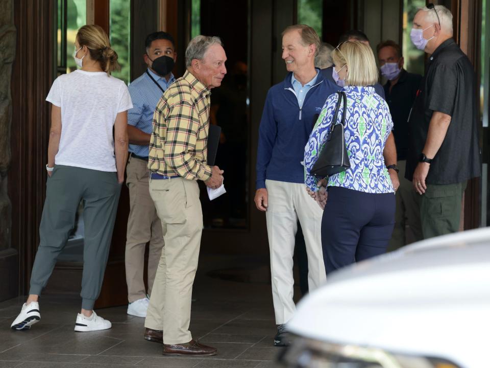 Michael Bloomberg talks to group of people outside Sun Valley Lodge