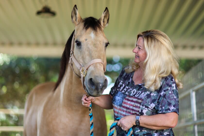 Yorba Linda, CA, Friday, January 21, 2022 - Yorba Linda resident Dee Dee Friedrich with Wyatt at their backyard stable. (Robert Gauthier/Los Angeles Times)