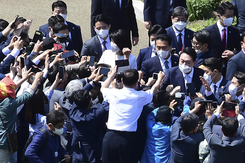 Supporters greet South Korean President Yoon Suk Yeol, center right, arrives for his inaugural ceremony at the the National Assembly in Seoul, South Korea, Tuesday, May 10, 2022. Yoon took office as South Korea’s new president Tuesday with a vow to pursue a negotiated settlement of North Korea's threatening nuclear program and an offer of “an audacious plan” to improve Pyongyang’s economy if it abandons its nuclear weapons. (Kim Min-hee/Pool Photo via AP)