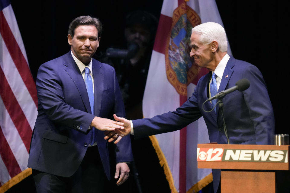 Florida Republican Gov. Ron DeSantis, left, shakes hands with former Gov. Charlie Crist, D-Fla., at the start of their televised gubernatorial debate, at Sunrise Theatre in Fort Pierce, Fla., on Monday, Oct. 24, 2022. / Credit: Rebecca Blackwell / AP