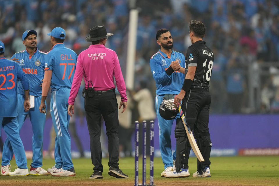 India's Virat Kohli, second right, shakes hands with New Zealand's Trent Boult after India won the ICC Men's Cricket World Cup first semifinal match against New Zealand in Mumbai, India, Wednesday, Nov. 15, 2023. (AP Photo/Rajanish Kakade)