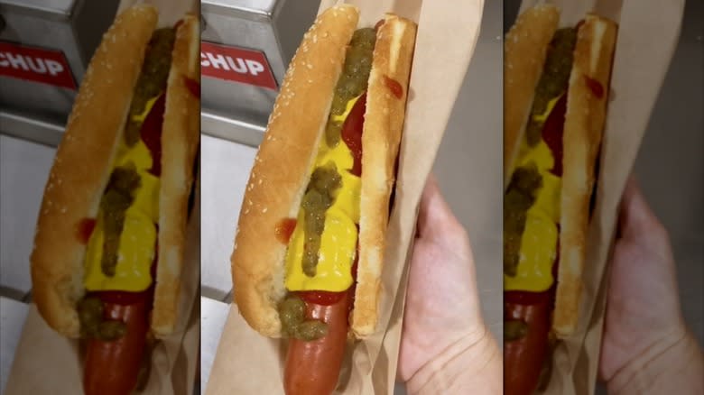 Person holding Costco hot dog