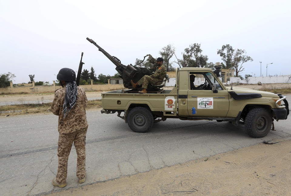 FILE - In this May 21, 2019 file photo, Tripoli government forces clash with forces led by Field Marshal Khalifa Hifter, south of the capital Tripoli, Libya. Two Libyan militia commanders and a Syrian war monitor group say Turkey is deploying Syrian extremists to fight in Libya's civil war. These extremists are affiliated with groups like al-Qaida and the Islamic State. They're fighting as mercenaries on behalf of the United Nations-supported government in Libya. The Libyan sources told The Associated Press that Turkey has airlifted more than 2,500 foreign fighters into Tripoli, and that “dozens” are extremist-affiliated. (AP Photo/Hazem Ahmed, File)