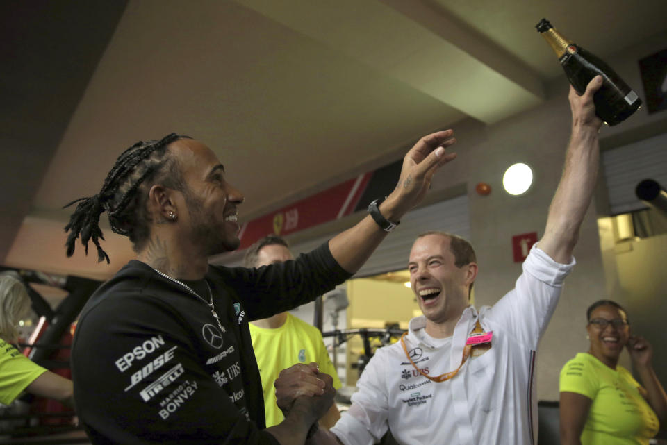 In this Oct. 27, 2019 photo, Mercedes driver Lewis Hamilton, of Britain, celebrates with his crew after winning the Formula One Mexico Grand Prix auto race at the Hermanos Rodriguez racetrack in Mexico City. The Mercedes driver overcame Ferrari’s front-row start to win on Sunday, pushing him so close to the season championship that he’s all but guaranteed to win it next week at the U.S. Grand Prix in Texas. (AP Photo/Marco Ugarte)