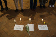 FILE - Papers with the words "Refuse COVID terror" and "Not foreign forces but internal forces" are placed on the ground near protesters gathering at the University of Hong Kong in Hong Kong, Tuesday, Nov. 29, 2022. The recent wave of protests against China's anti-virus restrictions was a ray of hope for some supporters of Hong Kong's own pro-democracy movement after local authorities stifled it using a national security law enacted in 2020, but not everyone agrees. (AP Photo/Bertha Wang, File)