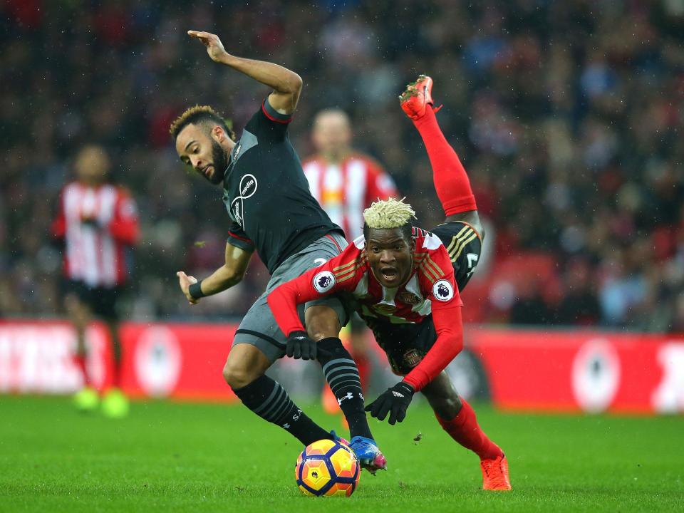 Dider N'dong is sent flying following a challenge from Nathan Redmond (Getty)