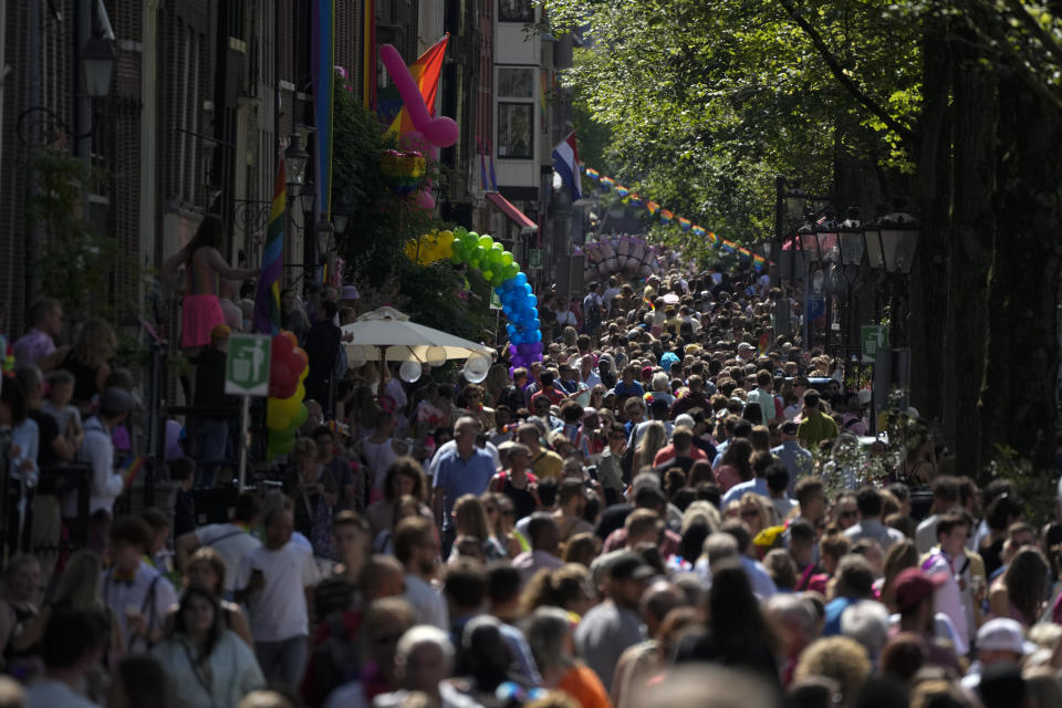 Hundreds of thousands of people lined canals in the Dutch capital to watch the colorful spectacle of the Pride Canal Parade return for the 25th edition after the last two events were canceled due to the COVID-19 pandemic, in Amsterdam, Netherlands, Saturday, Aug. 6, 2022. (AP Photo/Peter Dejong)