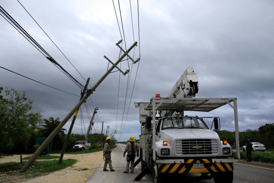 CFE personnel inspect light poles that were hit by Hurricane Beryl, in Tulum, Mexico, July 5, 2024. REUTERS/Raquel Cunha