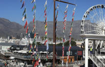 Cape Town's popular V&A Waterfront is photographed against a backdrop of the city's Table Mountain, Friday, July 31, 2020. For growing numbers of businesses and individuals who depend on the global tourism industry, the question is not so much when the coronavirus pandemic will end but how and if they'll survive until business picks up. (AP Photo/Nardus Engelbrecht)