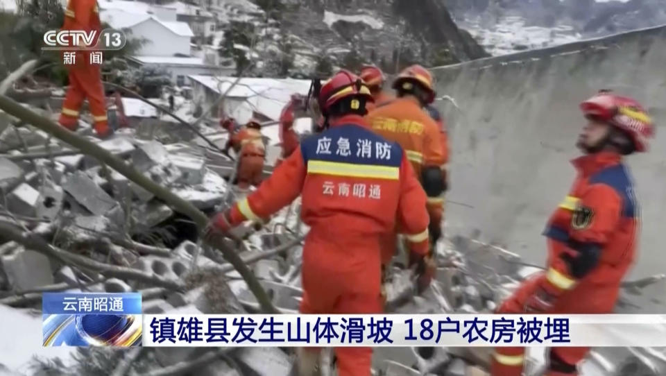 In this image taken from video footage run by China's CCTV, rescue workers search through rubbles in the aftermath of a landslide in liangshui village in southwestern China's Yunnan Province on Monday, Jan. 22, 2024. The landslide in southwestern China's mountainous Yunnan province early Monday buried dozens and forced the evacuation of hundreds. (CCTV via AP)