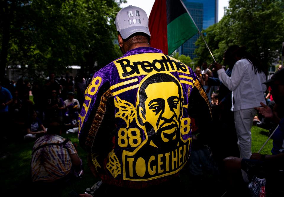 People gather outside the Hennepin County Government Center and listen to victim impact statements during the sentencing of Derek Chauvin on June 25, 2021 in Minneapolis, Minnesota.