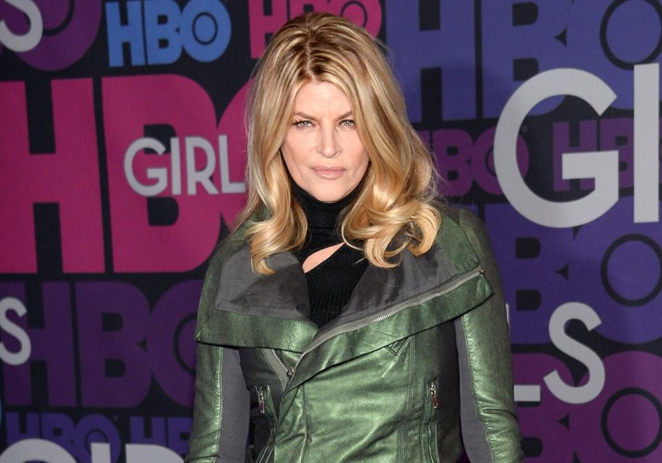 A woman poses on a red carpet