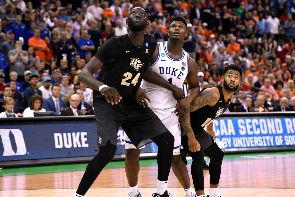 UCF's Tacko Fall boxes out Duke's Zion Williamson during their 2019 NCAA tournament game. (Getty)