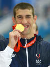 <b>Medal No. 12: </b>Michael Phelps poses with the gold medal during the medal ceremony for the Men's 200m Butterfly in Beijing.