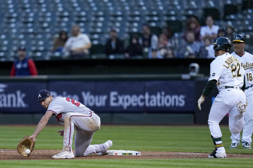 Atlanta Braves first baseman Matt Olson catches a throw from pitcher Bryce Elder for the out on Oakland Athletics' Ramón Laureano, right, during the sixth inning of a baseball game in Oakland, Calif., Tuesday, May 30, 2023. (AP Photo/Godofredo A. Vásquez)