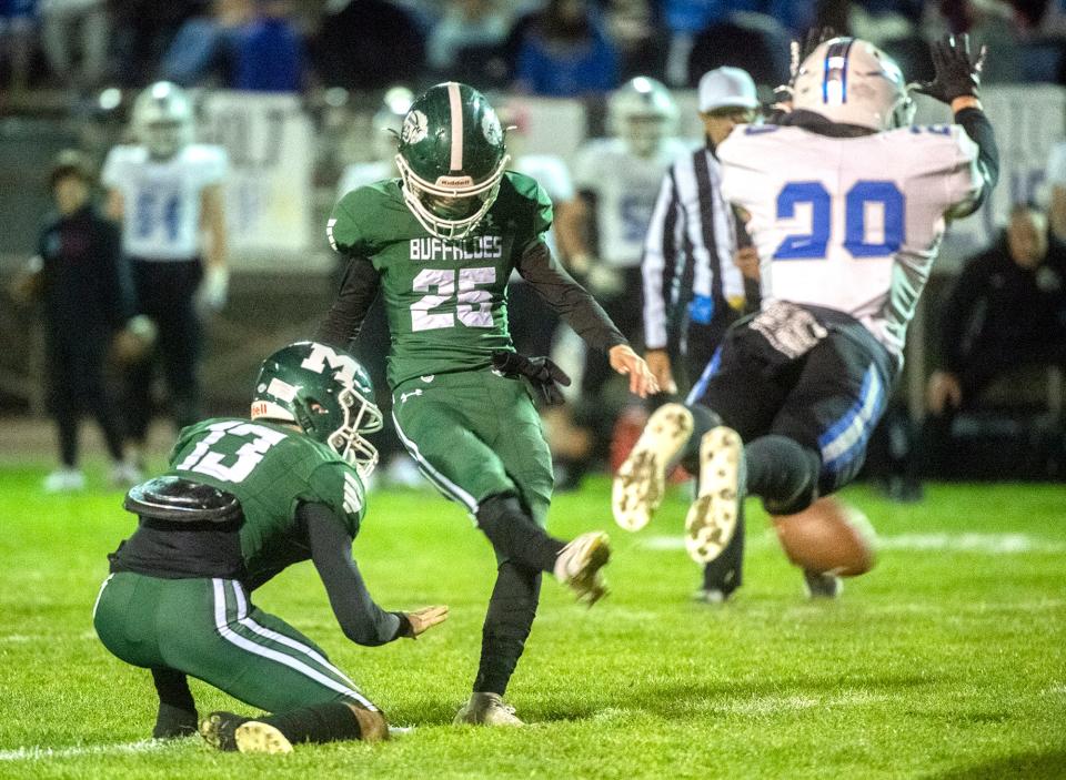 Manteca's Matt Kong kicks a PAT during a Sac-Joaquin Section Division II playoff against Rocklin game at Manteca's Gus Schmiedt Stadium.